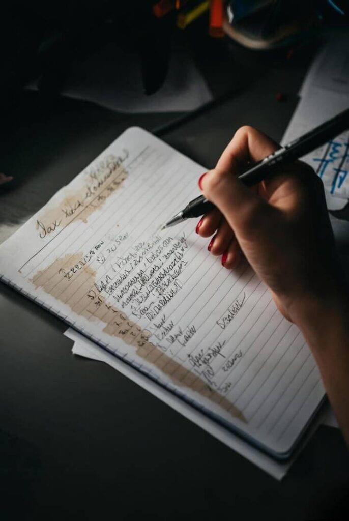 Scribbled tax tips on stained notepad, overhead peek.